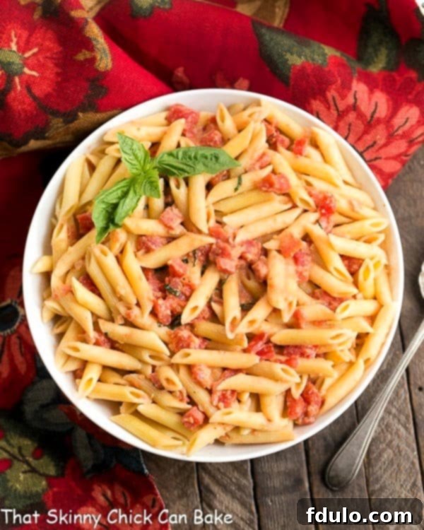 Penne alla Vodka in a serving bowl, garnished with fresh basil.