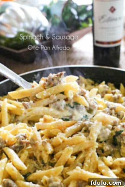 Spinach and Sausage One-Pan Alfredo in a skillet.
