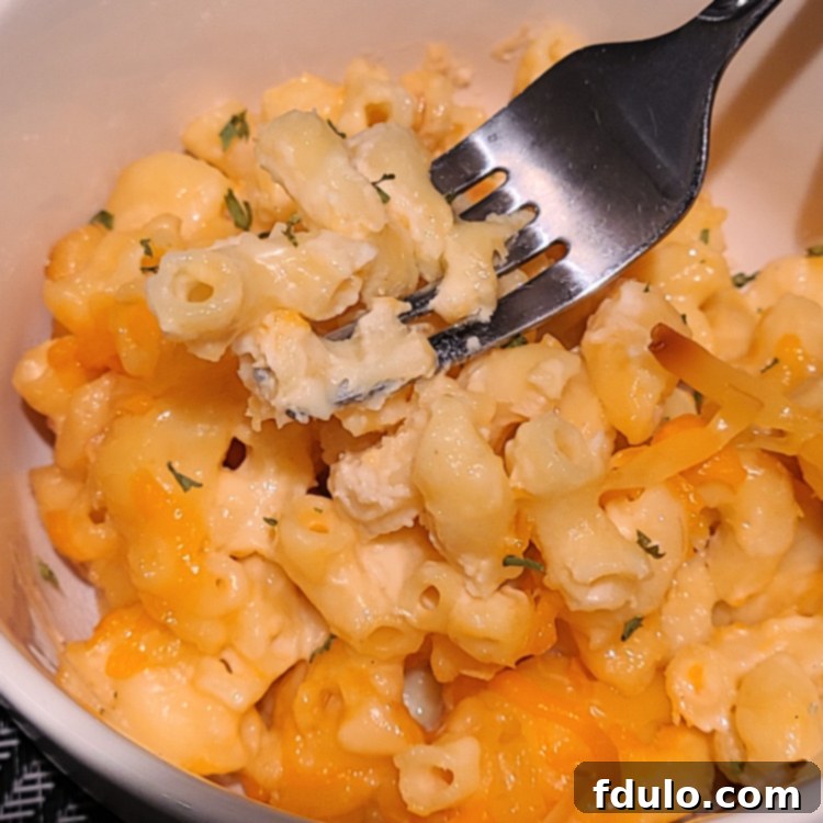Next-Level Smoked Sides 4 Smoked macaroni and cheese in white bowl with a fork