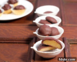 Assortment of homemade truffles and glossy chocolate-covered caramels artfully arranged in small bowls.