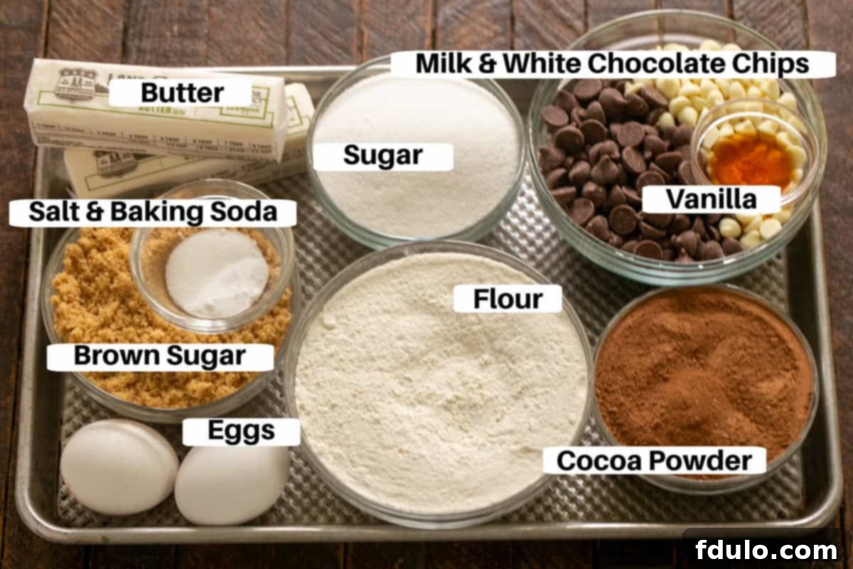 A curated display of essential ingredients for crafting perfect Chocolate Fudge Cookies. Labels highlight key components like flour, cocoa powder, sugars, butter, eggs, and a generous mix of milk and white chocolate chips, neatly arranged on a metal sheet pan.