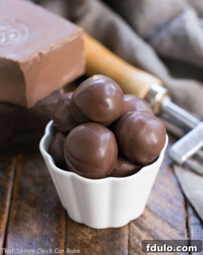 Chocolate Frangelico Truffles in a small white candy bowl, showcasing their rich, dark appearance and perfect shape.