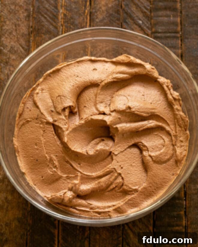 A bowl of creamy chocolate mousse, perfectly prepared and ready for filling.