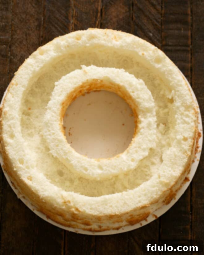 Hollowing out a trench in the angel food cake to create space for the mousse filling.