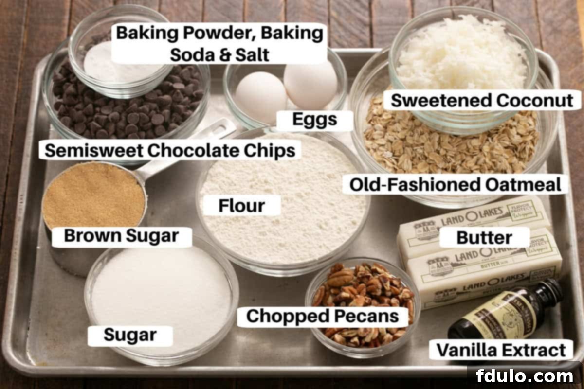 Hearty Cowboy Cookies: The Recipe You Need 2 A collection of ingredients for cowboy cookies, neatly arranged with labels on a metallic sheet pan, including flour, sugars, oats, chocolate chips, pecans, and coconut.