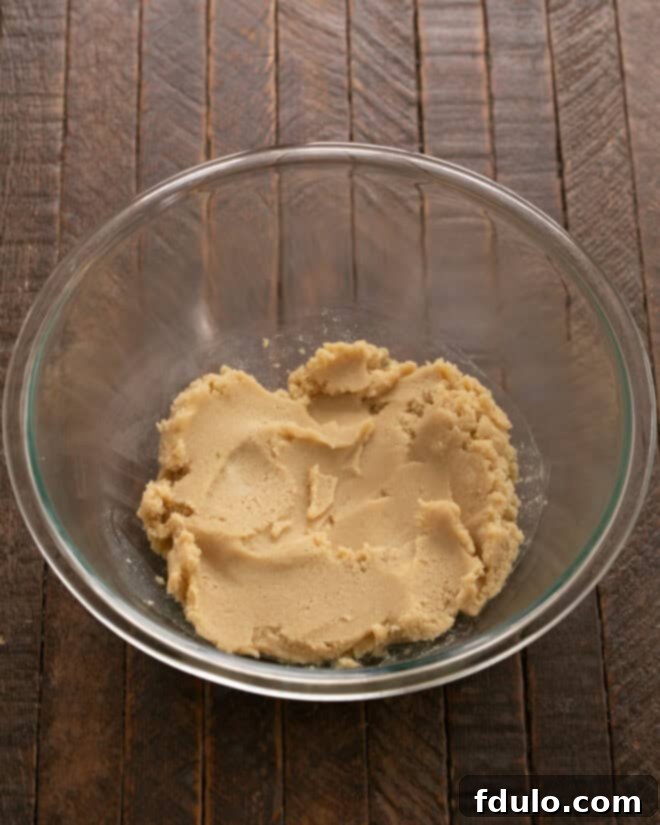 Hearty Cowboy Cookies: The Recipe You Need 3 Step 1: Beating softened butter in a mixer bowl.