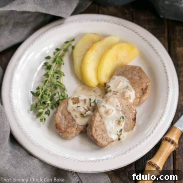 Apple Topped Pork Medallions with Calvados Cream Sauce, beautifully plated and ready to be served