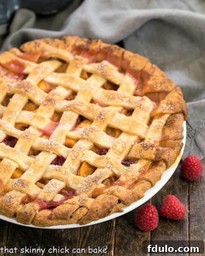 Peach Raspberry Pie in a white pie plate.