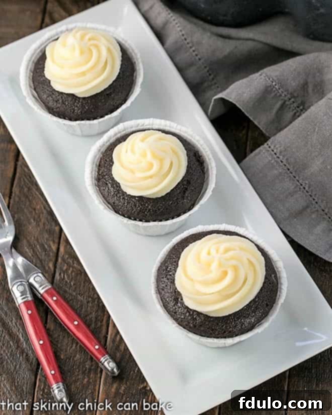 Frosted Black Bottom Cupcakes on a white tray, showcasing their rich chocolate cake and creamy white frosting.