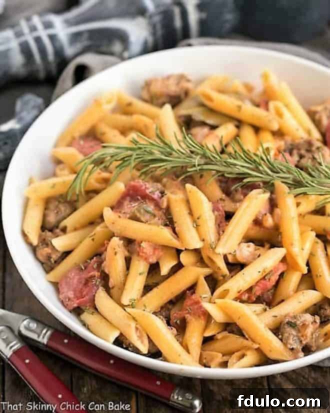 Creamy Italian Sausage Pasta in a white serving dish.