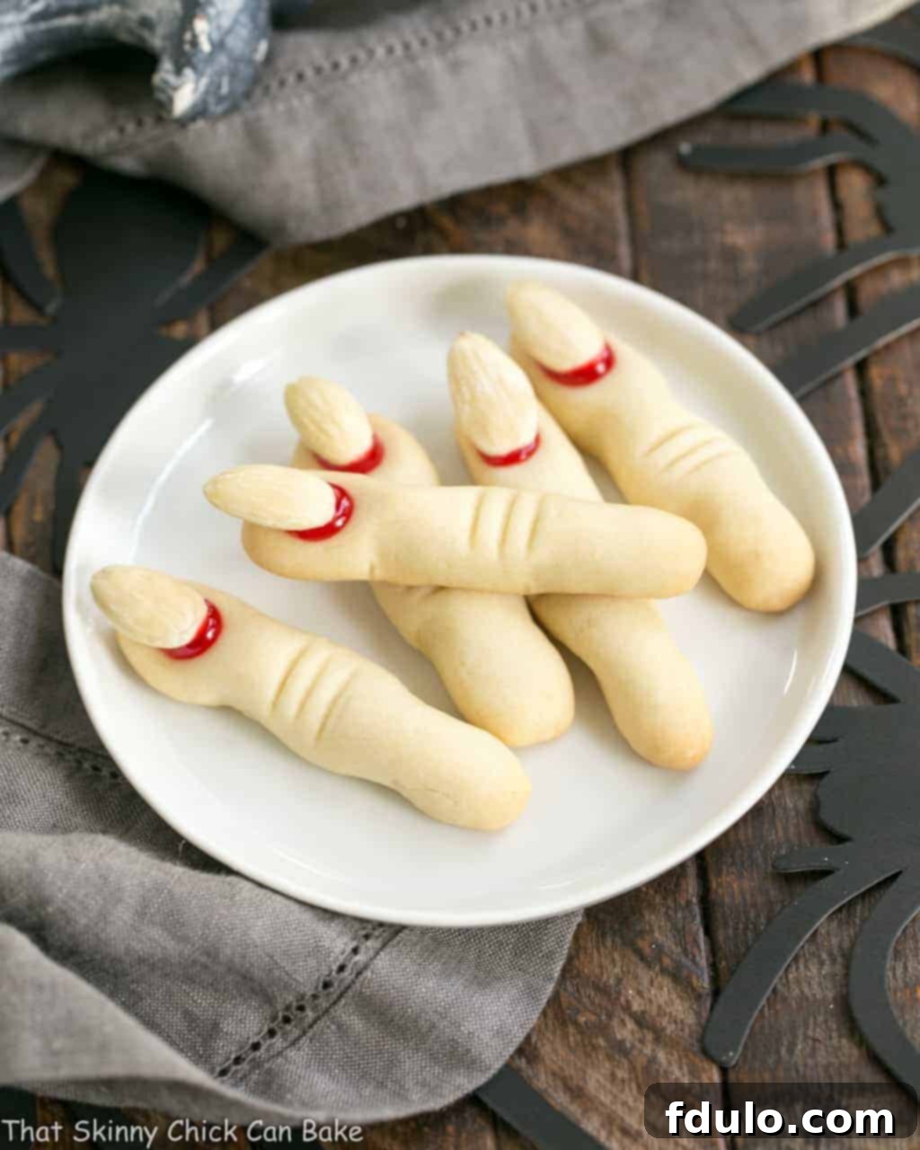 Close-up of Witches Fingers Cookies on a round white ceramic plate, ready to be served for Halloween.