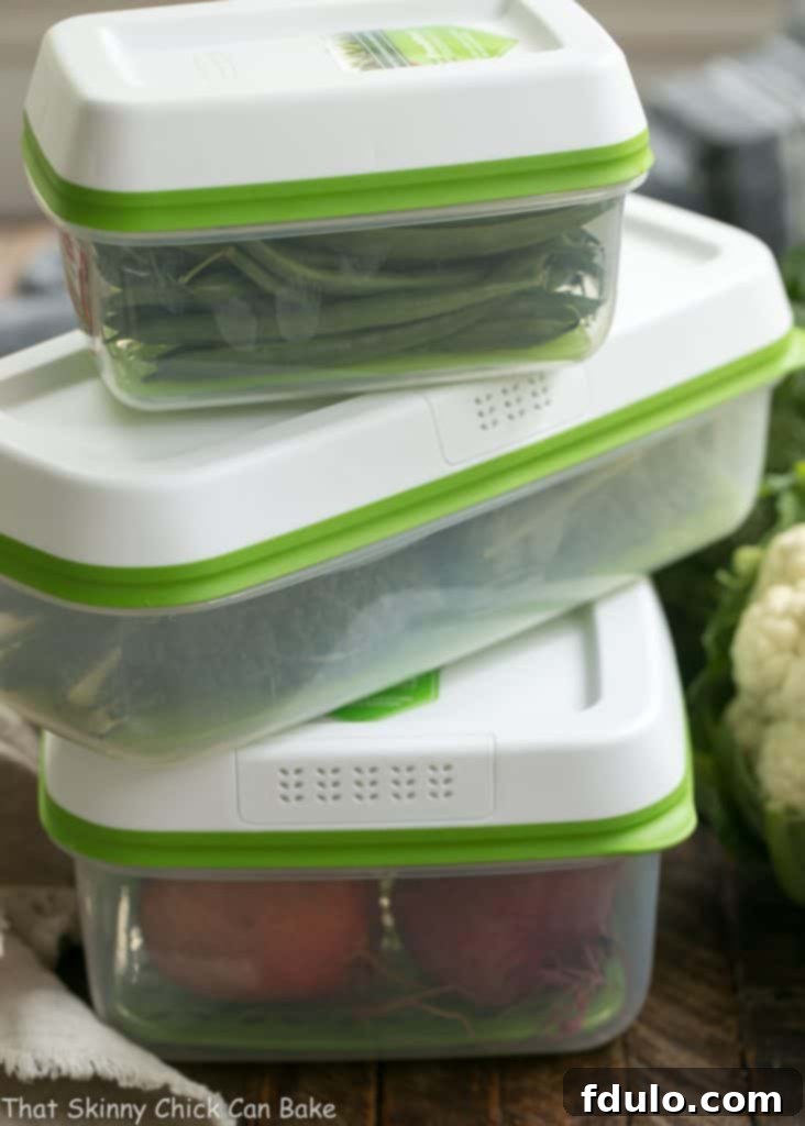 Close-up of a vibrant Roasted Fall Vegetable Salad, highlighting the textures of farro, spinach, goat cheese, and perfectly roasted butternut squash.