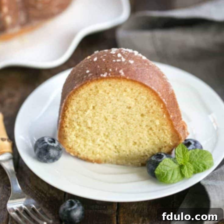 Golden Kentucky Butter Bundt 2 A slice of Kentucky butter bundt cake, showcasing its moist interior and golden crust, served on a plate.