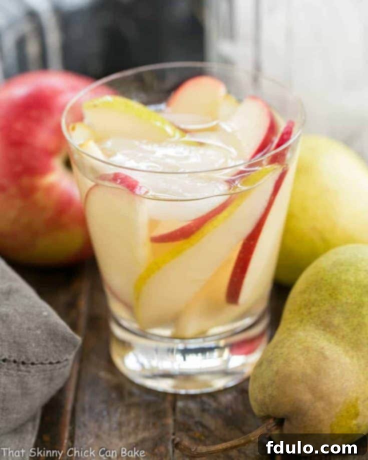 Apple Cider Sangria | An autumnal white wine sangria flavored with cider and pear brandy!