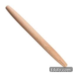 A classic French wooden rolling pin with tapered ends