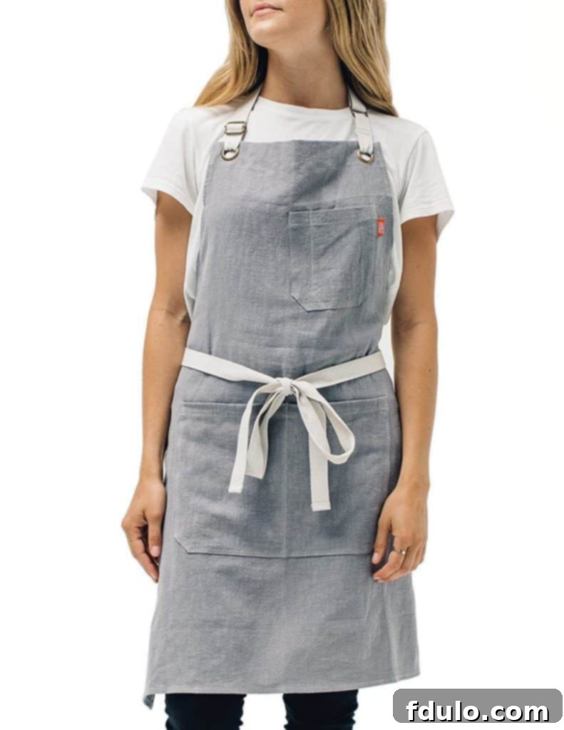 Stylish gray linen kitchen apron, perfect for keeping clothes clean while cooking