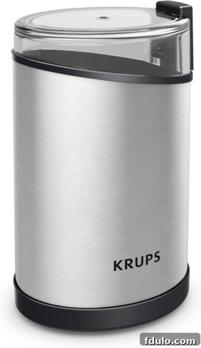 Shiny silver Krups coffee grinder with a modern design