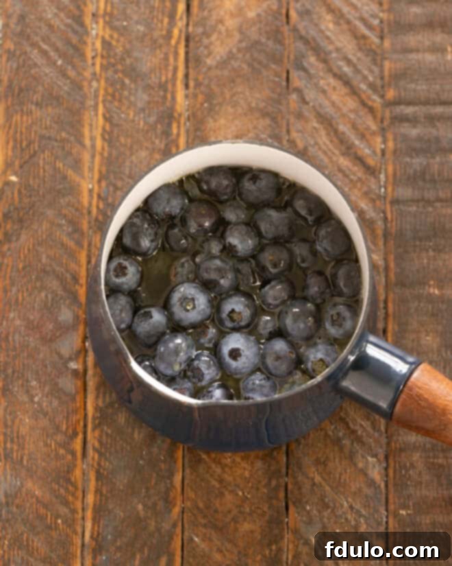 Step 7: Heat maple syrup with fresh blueberries in a saucepan until blueberries soften and syrup is warm.
