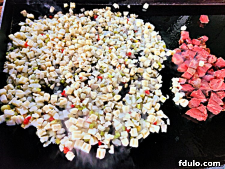 Prime Rib on Blackstone next to potatoes Obrien