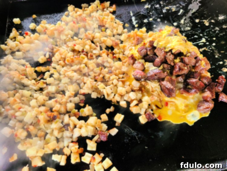 Prime Rib Breakfast Hash cooking on blackstone