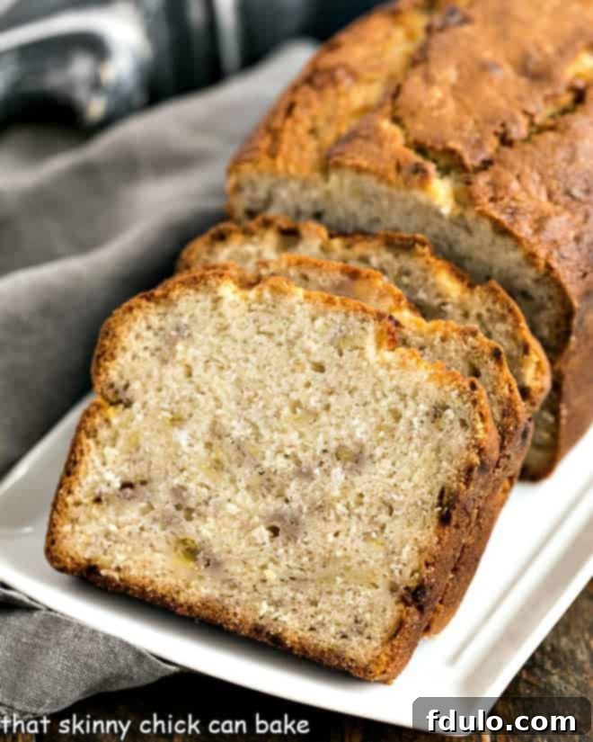 Buttermilk Banana Bread slices on a white ceramic tray.