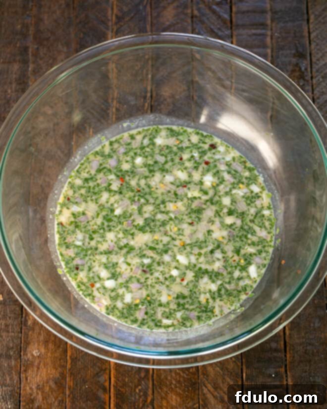 Whisking together the marinade ingredients in a bowl.