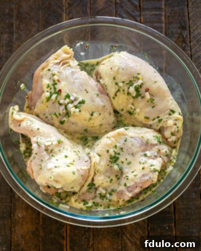 Chicken breasts marinating in a Ziploc bag.