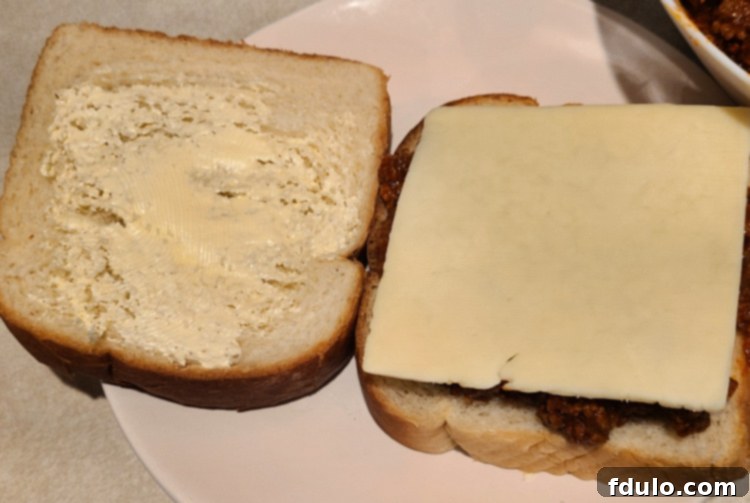 Sloppy Joe Grilled Cheese on bread before grilling with slice of cheese 