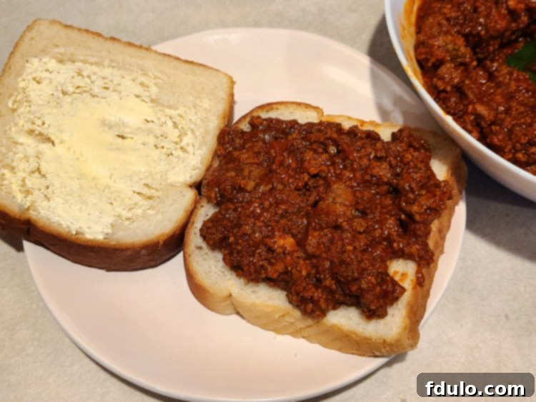 Sloppy Joe Grilled Cheese bread next to bowl full of sloppy joe 