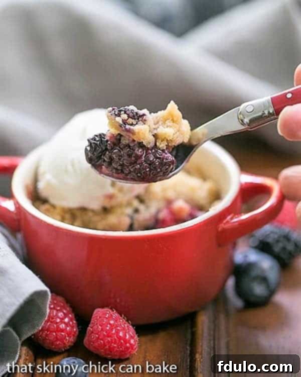 Personal Berry Crisp Bliss 2 A spoon with a smalll scoop removed from an Individual Berry Crisp.
