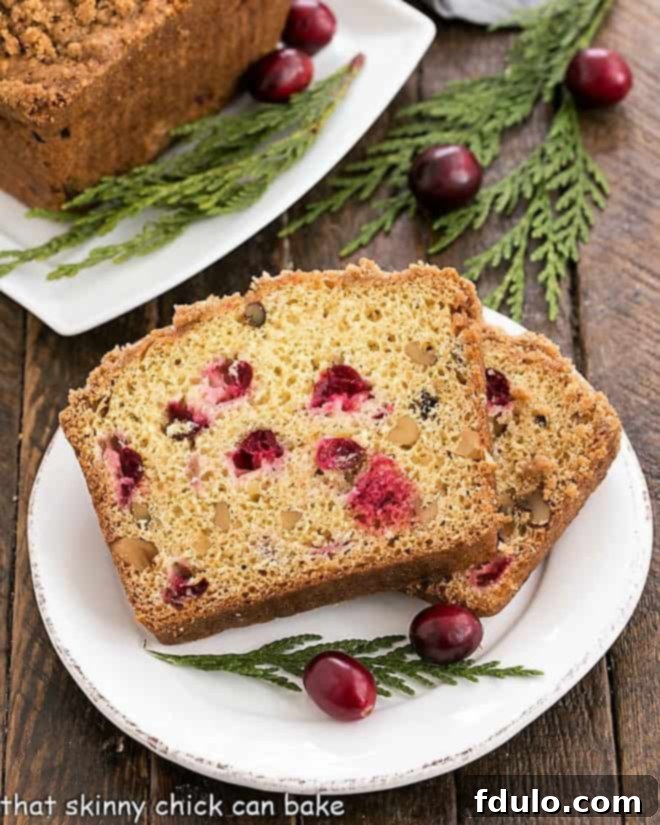 Streusel Topped Cranberry Orange Walnut Bread slices on a small white plate