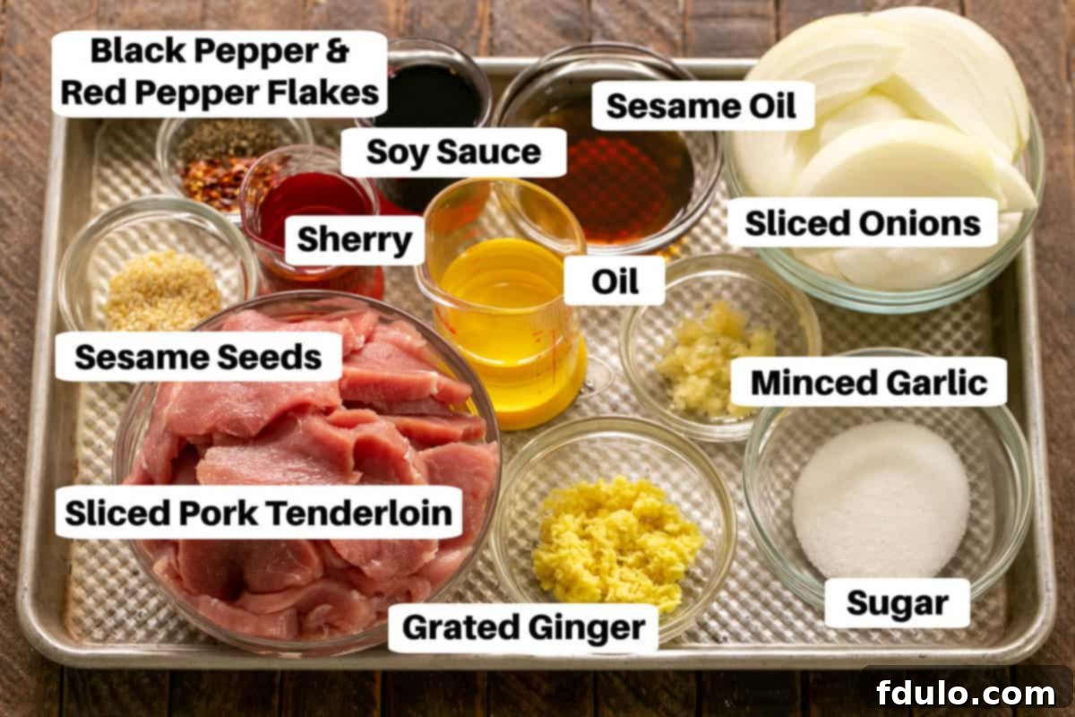 Classic Korean Pork Bulgogi 2 A collection of fresh Bulgogi ingredients, neatly labeled, arranged on a gleaming metal sheet pan, showcasing the simple yet vibrant components.
