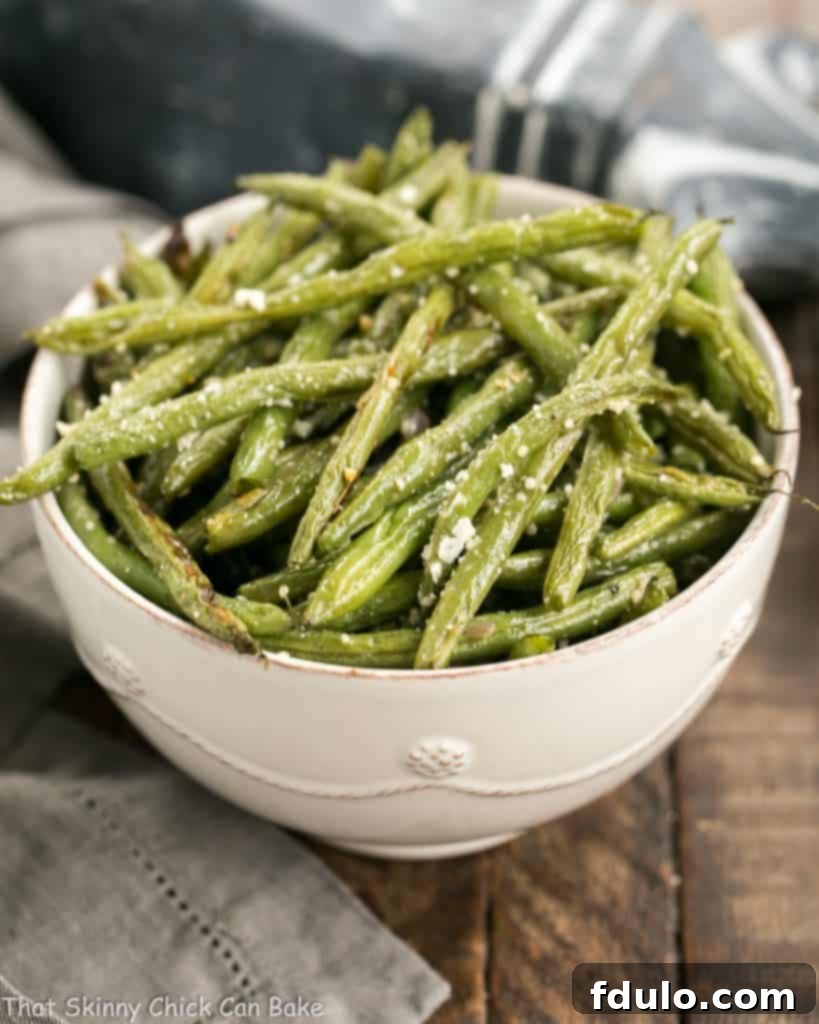 Garlic Parmesan Roasted Green Beans in a serving bowl, showcasing a vibrant green color and golden-brown parmesan