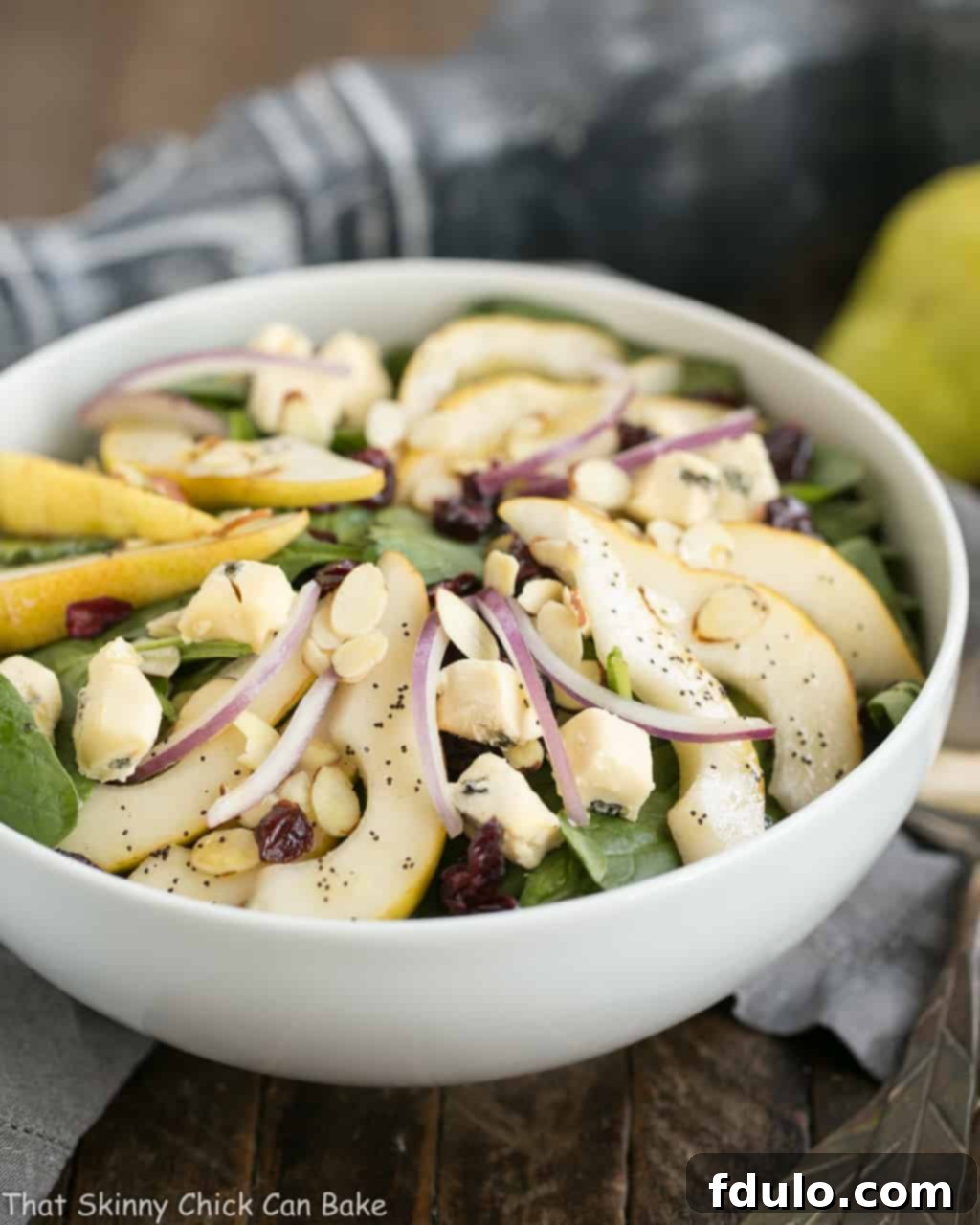 Jeweled Pear and Blue Cheese Spinach Salad 4 An overhead shot of the delicious Spinach Pear Salad with Cranberries and Blue Cheese, ready to be served.