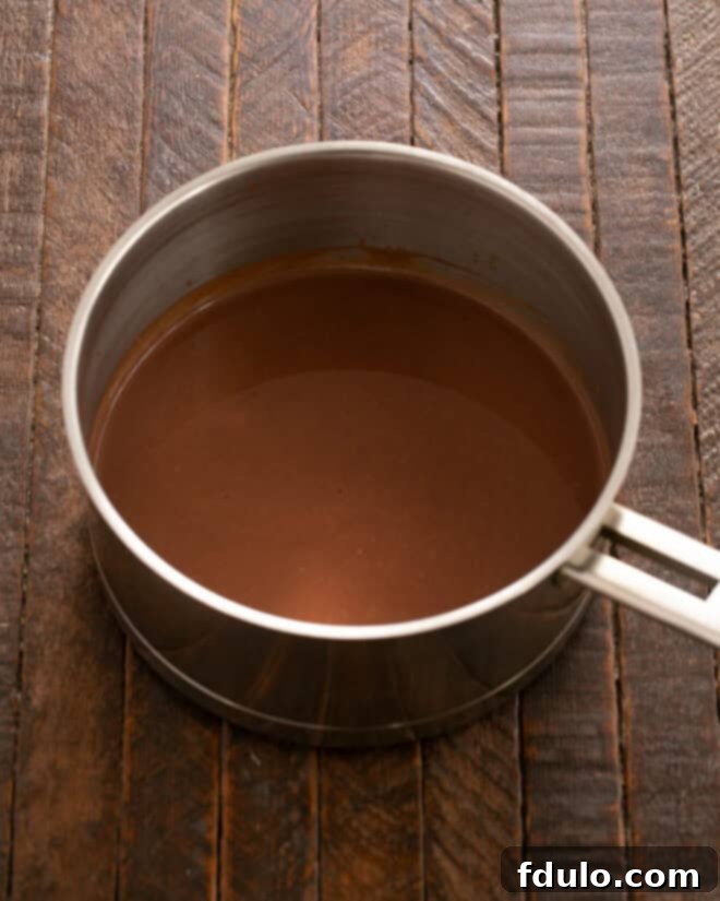 Add chopped chocolate to hot cream and stir until melted.