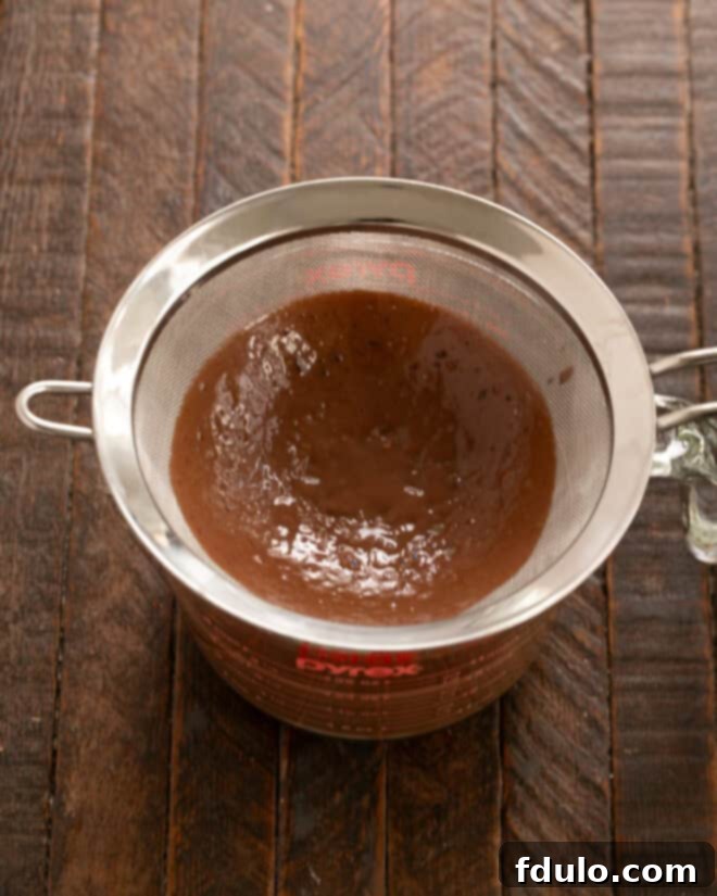 Whisk eggs and sugar, then temper with hot chocolate mixture.