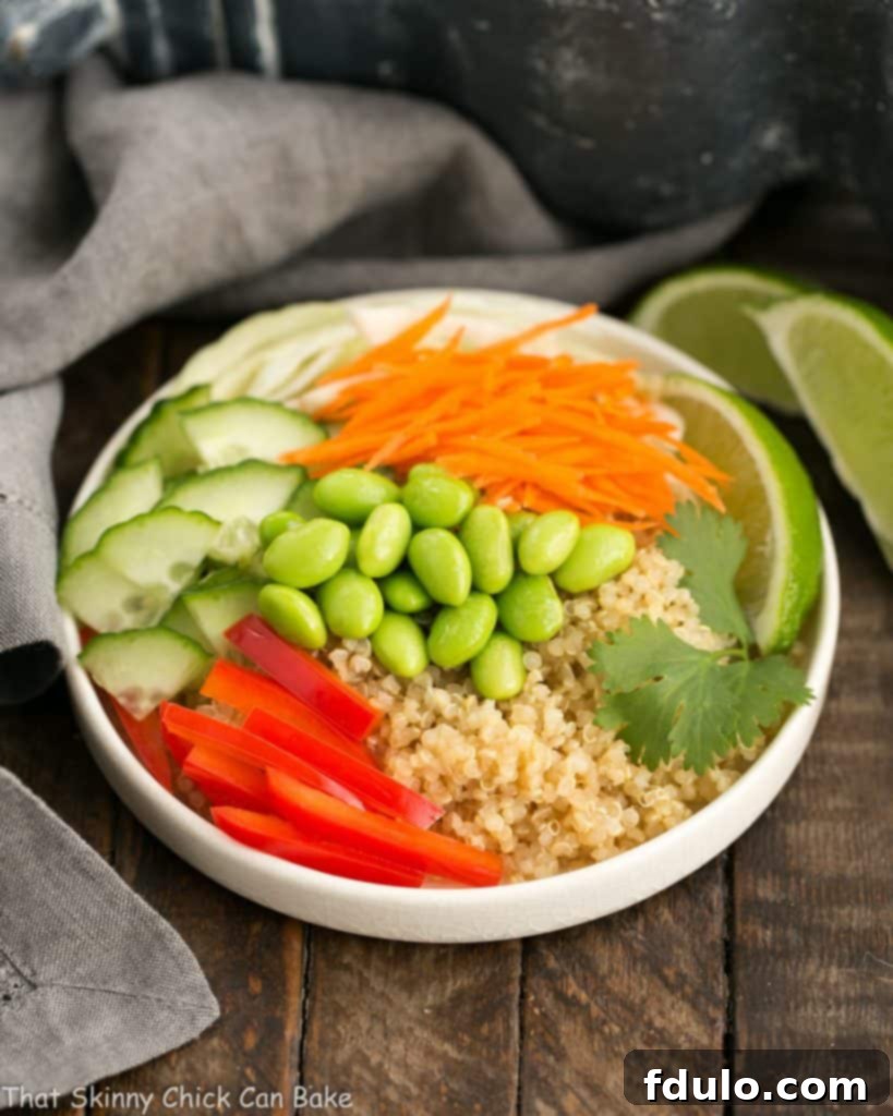 Vibrant Thai Vegetable Quinoa Bowl in a white bowl, showcasing fresh ingredients.