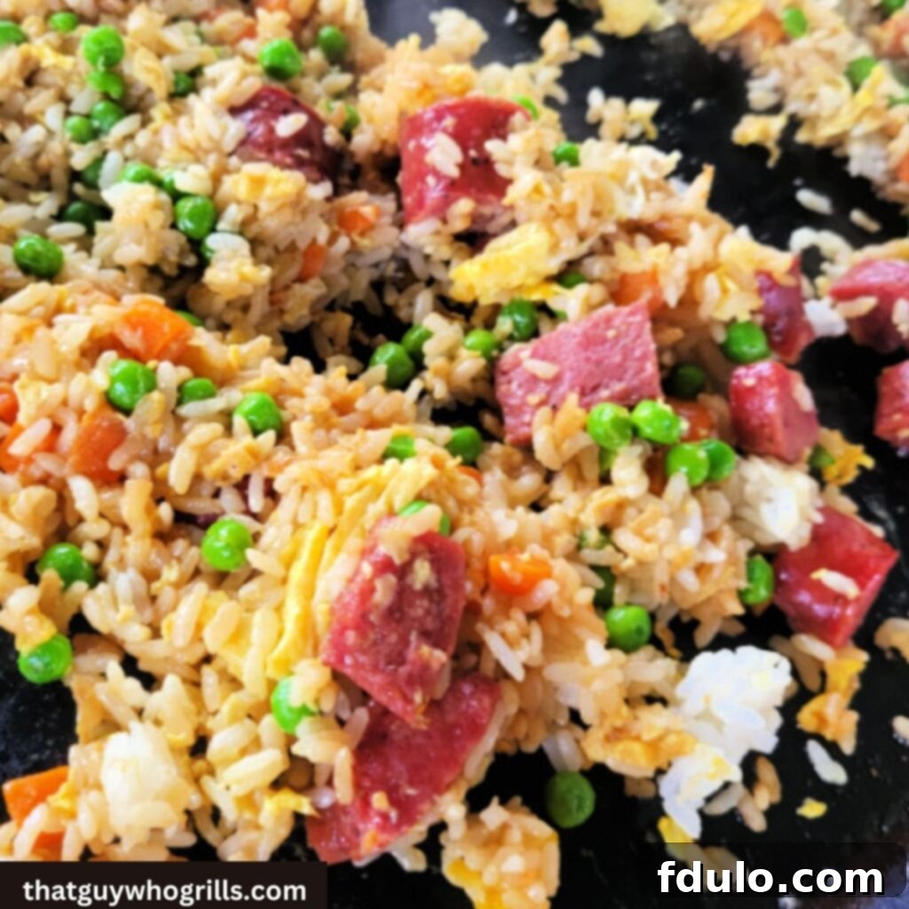 Blackstone Sausage Fried Rice Mixing on the Griddle