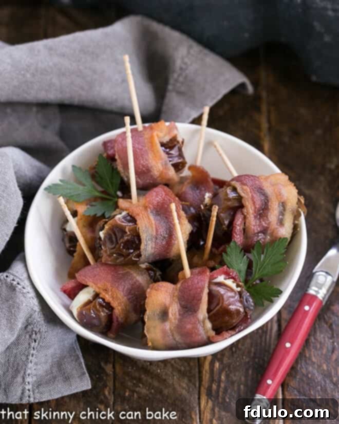 Bacon Wrapped Dates filled with goat or blue cheese for a super easy addictive appetizer! Overhead view of bacon wrapped dates in a white bowl, ready to be served