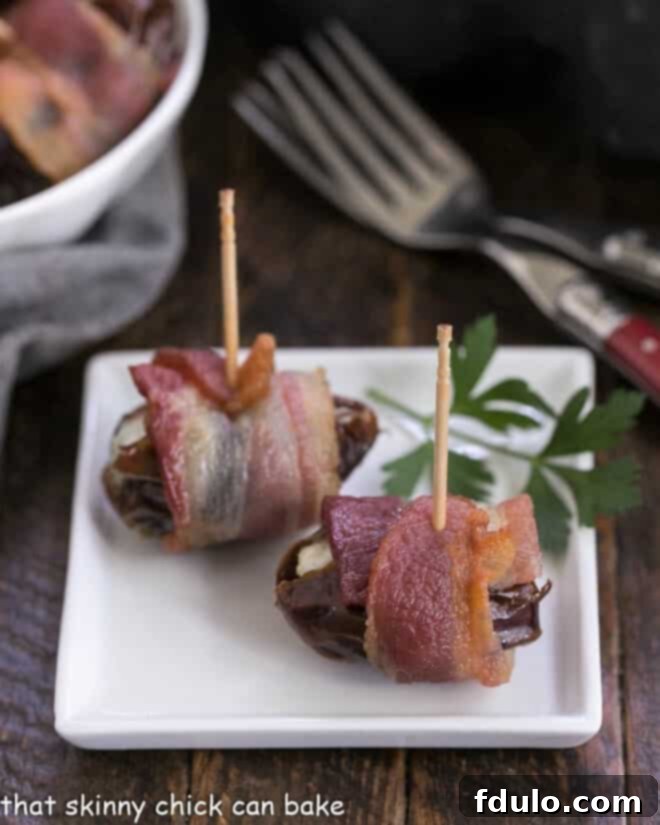 Bacon Wrapped Dates filled with goat or blue cheese for a super easy addictive appetizer! Bacon wrapped dates on a small white appetizer late with red handle forks, indicating they are ready to eat.