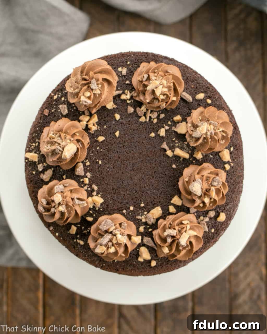 An overhead shot of the Triple Layer Chocolate Toffee Cake, beautifully sliced and ready to be served, showcasing its rich chocolate layers and toffee crunch.