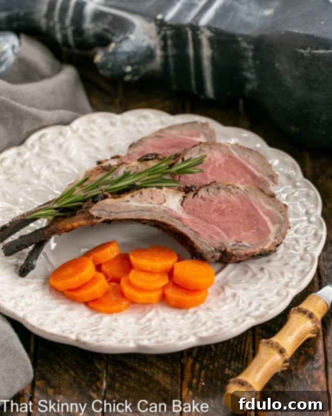 Marinated and perfectly grilled lamb chops served on a elegant dinner plate, accompanied by a side of colorful carrot coins, highlighting the enticing crust and tender interior.