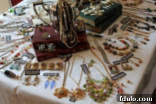 A beautifully arranged table overflowing with a diverse collection of handmade jewelry, inviting guests to explore unique pieces.
