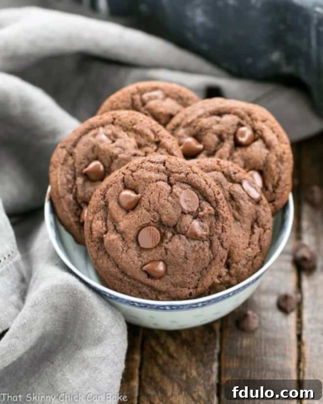 Dark Chocolate Pudding Cookies in a blue and white ceramic bowl. A close-up shot showcasing their rich color and soft texture.