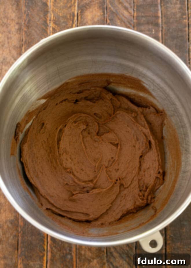 Step 1: Mixing butter, brown sugar, pudding mix, eggs, and vanilla in a stand mixer bowl.