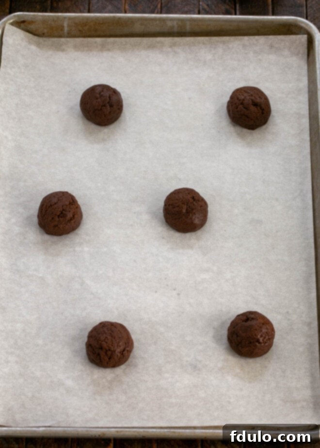 Step 4: Dough being rolled into tablespoon-sized balls, ready for baking.