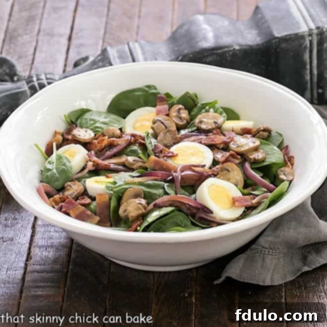 Best Spinach Salad in a white serving bowl