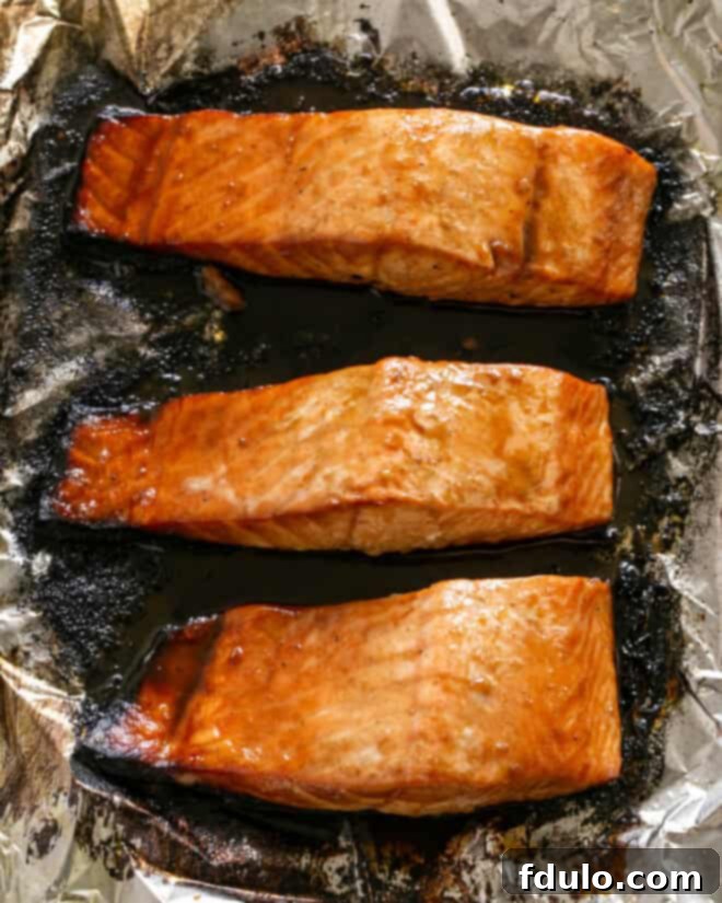 Broiled salmon with a beautiful caramelized glaze, ready to be plated and enjoyed.