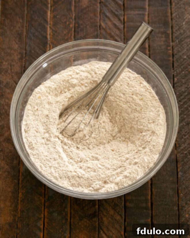 Dry ingredients for Irish Brown Bread being whisked together in a large mixing bowl.