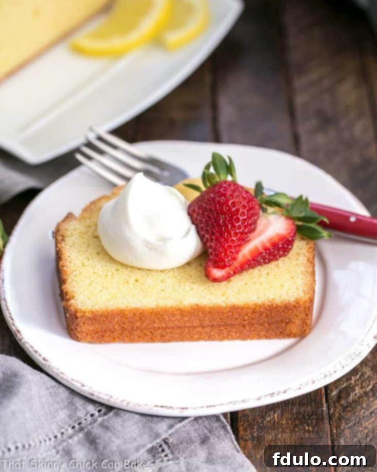 Glazed Lemon Pound Cake - served with whipped cream and berries for a delightful dessert